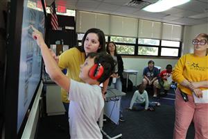 student and staff at smartboard