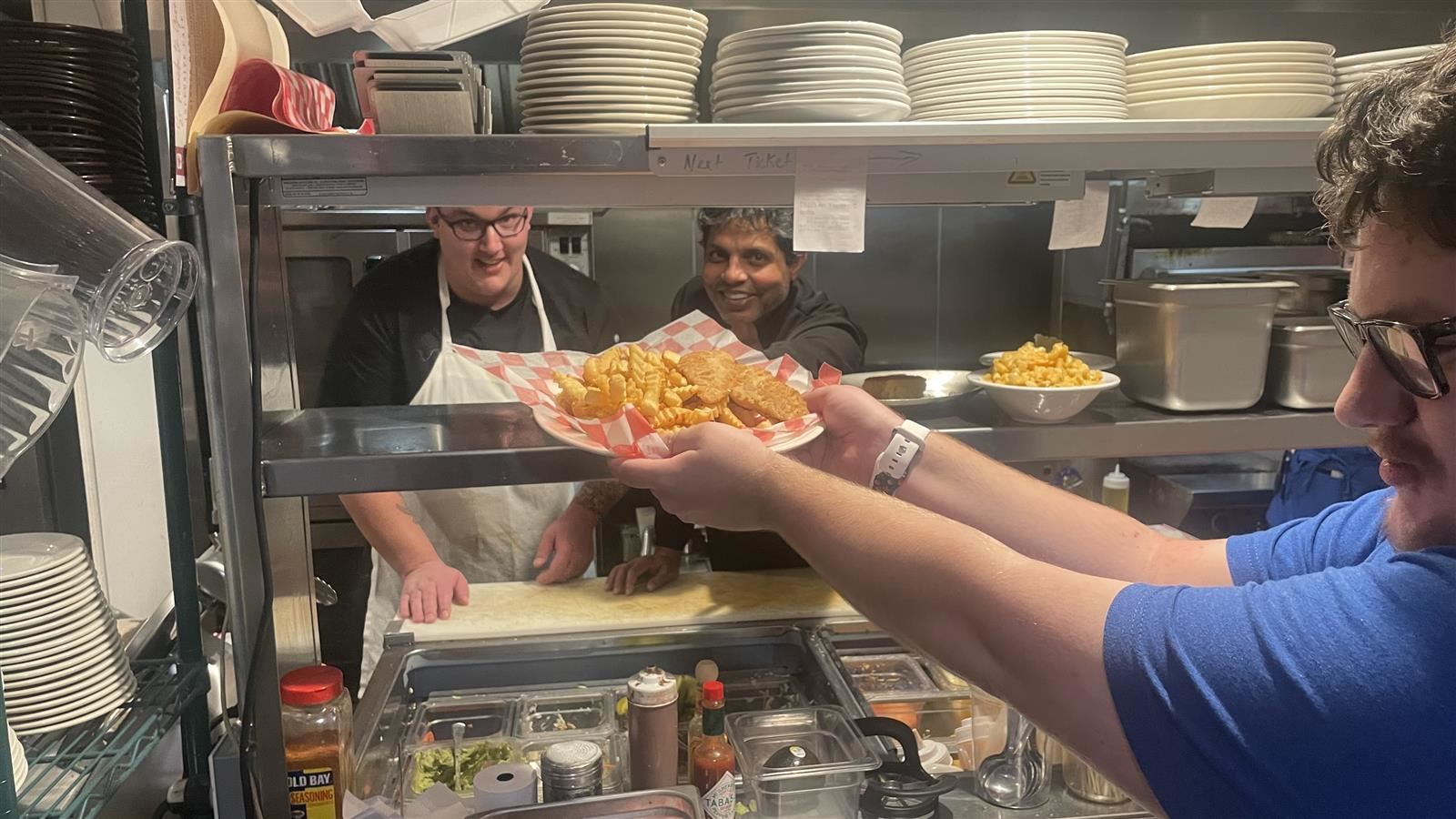 student serving french fries