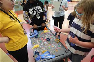 Vanguard staff and students assembling a puzzle