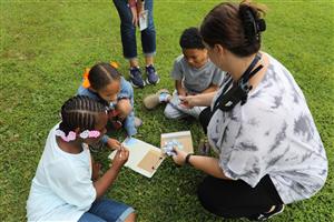 Vanguard staff and students assembling a puzzle