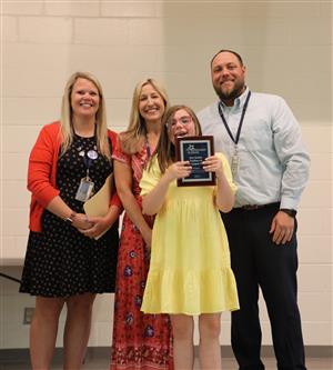 Vanguard staff and student smiling for a photo